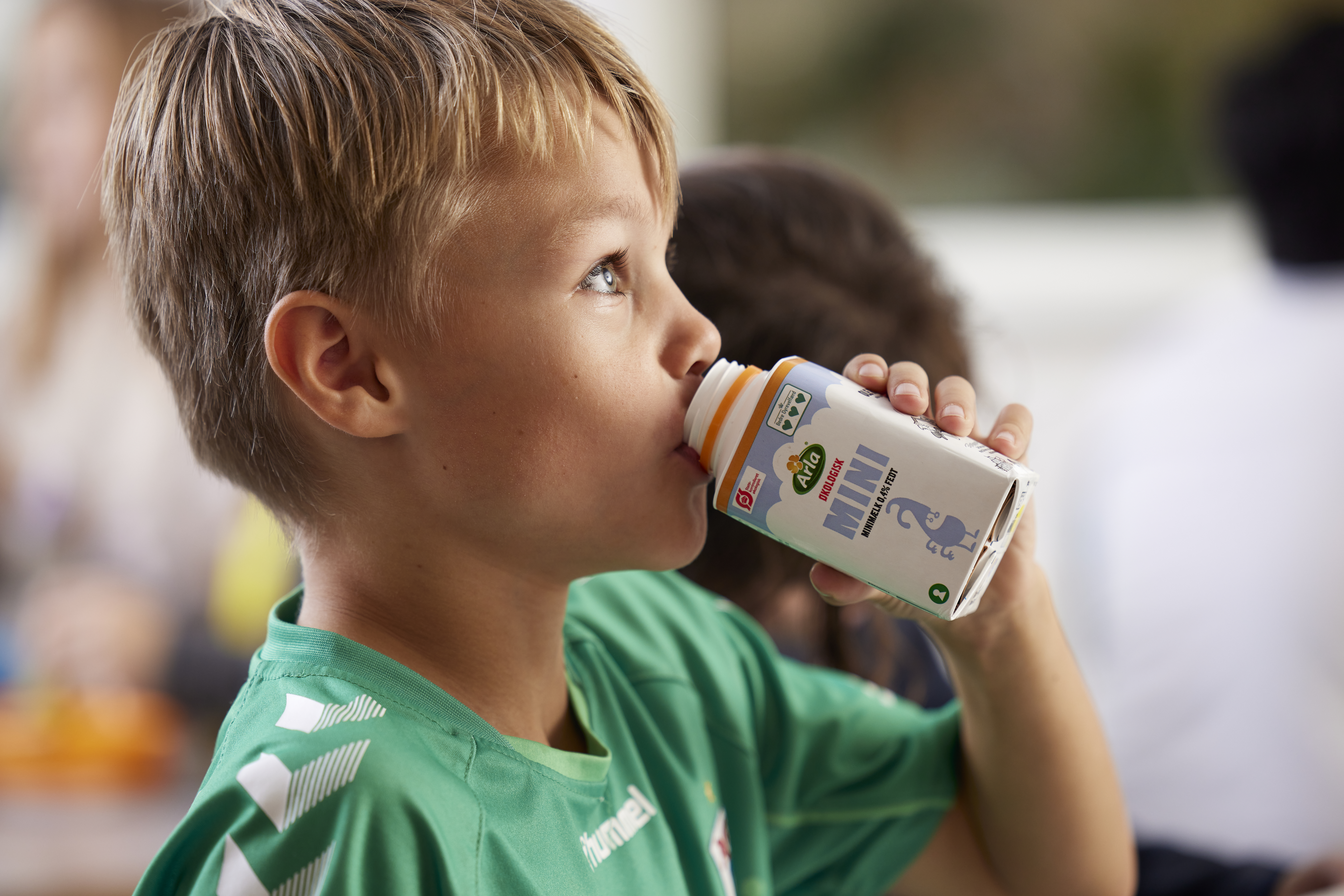Boy drinking from a school milk carton